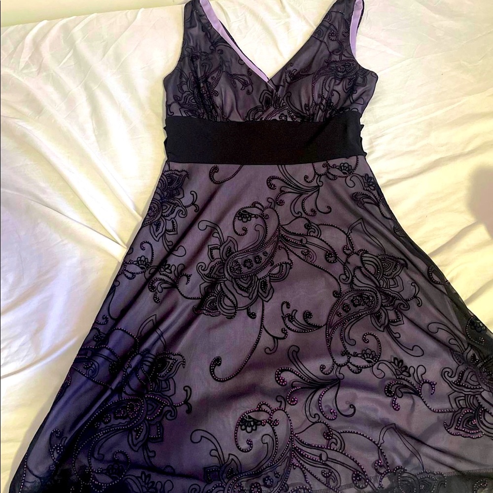 Woman’s purple and black beaded dress. Fits woman’s size medium